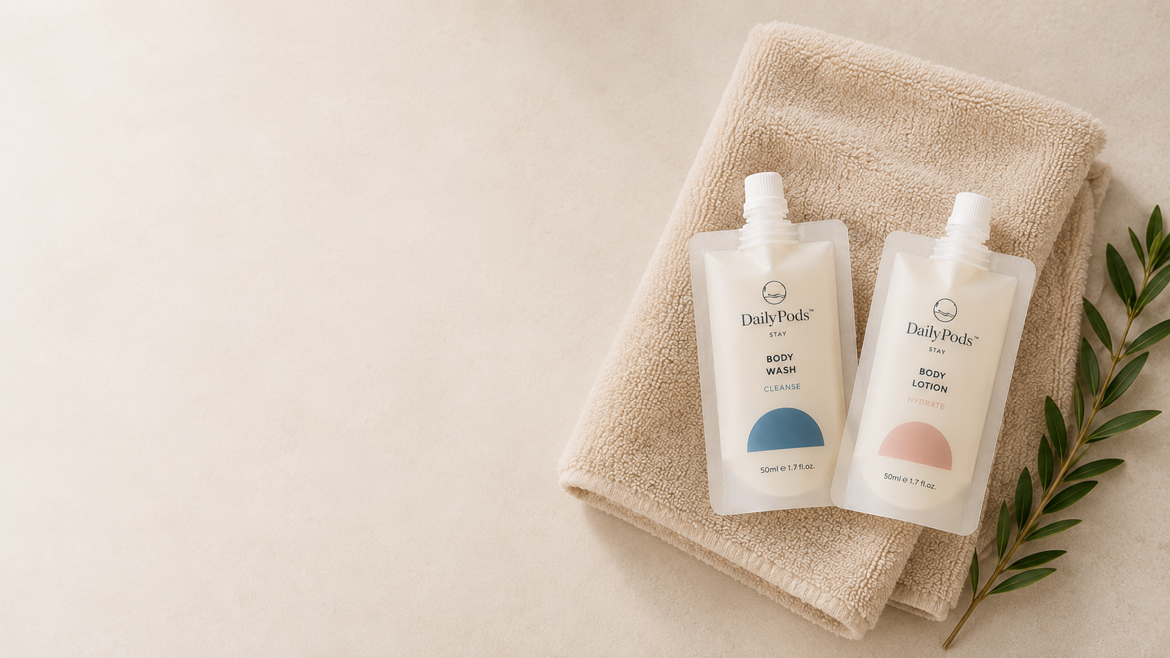 DailyPods body wash and lotion pouches arranged on folded towels